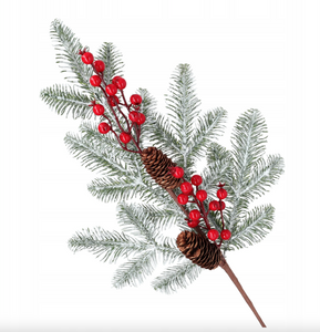 Christmas decoration - a snow-covered spruce branch with rowan berries and cones