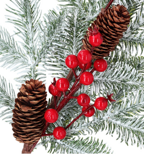 Christmas decoration - a snow-covered spruce branch with rowan berries and cones